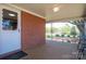 Covered front porch featuring brick accent wall and outdoor lighting fixture at 3340 Wrenwood Dr, Newton, NC 28658