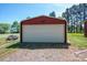 Exterior shot of the detached garage with white door and eagle decoration at 3340 Wrenwood Dr, Newton, NC 28658