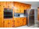 A kitchen with wood cabinets, backsplash, stainless steel appliances, island and light flooring at 3340 Wrenwood Dr, Newton, NC 28658
