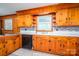 A kitchen with wood cabinets, backsplash, stainless steel appliances, island and light flooring at 3340 Wrenwood Dr, Newton, NC 28658