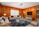 Comfortable living room with wood paneling, hardwood floors, and plenty of natural light at 3340 Wrenwood Dr, Newton, NC 28658