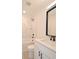 Modern bathroom featuring marble tiled shower with niche and vanity with black hardware at 406 W Marion St, Kershaw, SC 29067