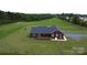 Aerial view of home with a long driveway and expansive yard at 485 Hilltop Rd, Oakboro, NC 28129