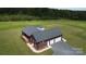 Brick home with an attached three-car garage, a wooden deck, and a gravel driveway at 485 Hilltop Rd, Oakboro, NC 28129