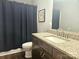 Bathroom featuring vanity with granite countertop, framed mirror and dark blue shower curtain at 485 Hilltop Rd, Oakboro, NC 28129