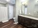 Bathroom features a dual sink vanity with granite countertops and a shower and tub at 485 Hilltop Rd, Oakboro, NC 28129