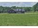 Inviting single-Gathering home boasting a brick facade and covered front porch, nestled on a spacious lot at 485 Hilltop Rd, Oakboro, NC 28129