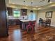 Eat-in kitchen boasts a center island with counter seating, stainless steel appliances, and hardwood flooring at 485 Hilltop Rd, Oakboro, NC 28129