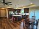 Spacious kitchen featuring a stainless steel refrigerator, large center island, and eat in dining area at 485 Hilltop Rd, Oakboro, NC 28129