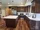 Well-equipped kitchen features stainless steel appliances, a center island with seating, and quartz countertops at 485 Hilltop Rd, Oakboro, NC 28129
