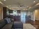 Bright living space featuring a stylish couch, and an open view of the modern kitchen at 485 Hilltop Rd, Oakboro, NC 28129
