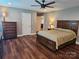 Comfortable main bedroom featuring hardwood floors, neutral paint, and access to the ensuite bath at 485 Hilltop Rd, Oakboro, NC 28129