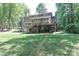 Large, grassy backyard with deck and stair access to upper level of home at 512 Saint Cloud Dr, Statesville, NC 28625