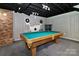 Finished basement with a pool table, exposed ceiling, brick fireplace and unique wall decor at 512 Saint Cloud Dr, Statesville, NC 28625