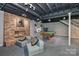 Finished basement featuring a brick fireplace, exposed ceiling, and a pool table at 512 Saint Cloud Dr, Statesville, NC 28625