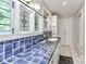 Bathroom showcasing blue tiled countertop, white cabinets, and decorative mirrors at 512 Saint Cloud Dr, Statesville, NC 28625