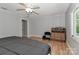 Bedroom with light walls, wood floors, ceiling fan, natural light, and dresser with bottles at 512 Saint Cloud Dr, Statesville, NC 28625