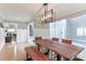Bright dining room featuring hardwood floors, wooden table, and decorative lighting fixture at 512 Saint Cloud Dr, Statesville, NC 28625