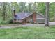 Charming home featuring brick chimney, mature trees, and well-maintained lawn at 512 Saint Cloud Dr, Statesville, NC 28625