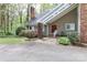 Beautiful front entrance with covered walkway, brick accents, and lush landscaping at 512 Saint Cloud Dr, Statesville, NC 28625