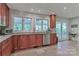 Kitchen area featuring granite countertops, cherry wood cabinets, and stainless steel appliances at 512 Saint Cloud Dr, Statesville, NC 28625