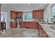Well-lit kitchen featuring stainless steel appliances, granite countertops, and cherry wood cabinetry at 512 Saint Cloud Dr, Statesville, NC 28625