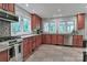 Bright kitchen featuring granite countertops, cherry wood cabinets, and stainless steel appliances at 512 Saint Cloud Dr, Statesville, NC 28625