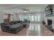 Spacious living room featuring hardwood floors, fireplace, and large windows with backyard views at 512 Saint Cloud Dr, Statesville, NC 28625