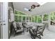 Relaxing sunroom with seating, a ceiling fan, and views of the wooded property at 512 Saint Cloud Dr, Statesville, NC 28625