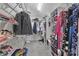 Walk-in closet with shelves, hanging rods, and various clothing items at 512 Saint Cloud Dr, Statesville, NC 28625