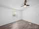 Bedroom with wood-look floors, ceiling fan, and a bright window at 5318 Austin Rd, Monroe, NC 28112