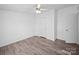 Bedroom with wood-look floors, ceiling fan, closet, and bright white walls at 5318 Austin Rd, Monroe, NC 28112