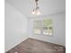 Dining room with wood-look floors, chandelier, and natural light at 5318 Austin Rd, Monroe, NC 28112