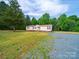 Pristine single story home with rock driveway and wooded backdrop at 5318 Austin Rd, Monroe, NC 28112