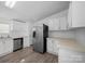 Bright kitchen features stainless steel refrigerator and white cabinetry at 5318 Austin Rd, Monroe, NC 28112