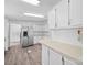 Bright kitchen features stainless steel refrigerator and white cabinetry at 5318 Austin Rd, Monroe, NC 28112