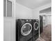 Convenient laundry area with modern washer and dryer units and adjacent storage space at 5318 Austin Rd, Monroe, NC 28112