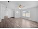 Bright living room with wood-look floors, ceiling fan, and many windows at 5318 Austin Rd, Monroe, NC 28112