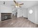 Open living room features a brick fireplace and wood-look flooring at 5318 Austin Rd, Monroe, NC 28112