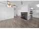 Open living room features a brick fireplace and wood-look flooring at 5318 Austin Rd, Monroe, NC 28112