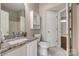 Bathroom featuring white marble floors, granite counters, and updated vanity at 542 Goldstaff Ln, Charlotte, NC 28273