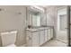 Bathroom featuring a dual vanity with granite countertops and updated lighting at 542 Goldstaff Ln, Charlotte, NC 28273