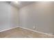 Bright bedroom with neutral carpet and gray walls at 542 Goldstaff Ln, Charlotte, NC 28273