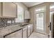 Well-lit kitchen featuring granite countertops, stainless steel appliances, and mosaic backsplash at 542 Goldstaff Ln, Charlotte, NC 28273