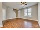 Spacious living room with hardwood floors, a ceiling fan, and staircase at 542 Goldstaff Ln, Charlotte, NC 28273