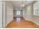 Open living area with hardwood floors, white trim, windows, and recessed lighting at 542 Goldstaff Ln, Charlotte, NC 28273