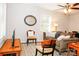 Bright living room with wood floors, ceiling fan, comfortable seating, and decorative mirror at 602 Childs St, Lincolnton, NC 28092