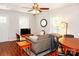 Inviting living room featuring wood floors, a ceiling fan, a large sofa, and natural light at 602 Childs St, Lincolnton, NC 28092