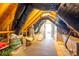 Unfinished attic space with exposed ductwork, plywood subflooring and a small amount of storage at 6029 Bountiful St, Belmont, NC 28012