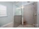 Modern bathroom features a glass shower, tile walls, and a bench at 6029 Bountiful St, Belmont, NC 28012